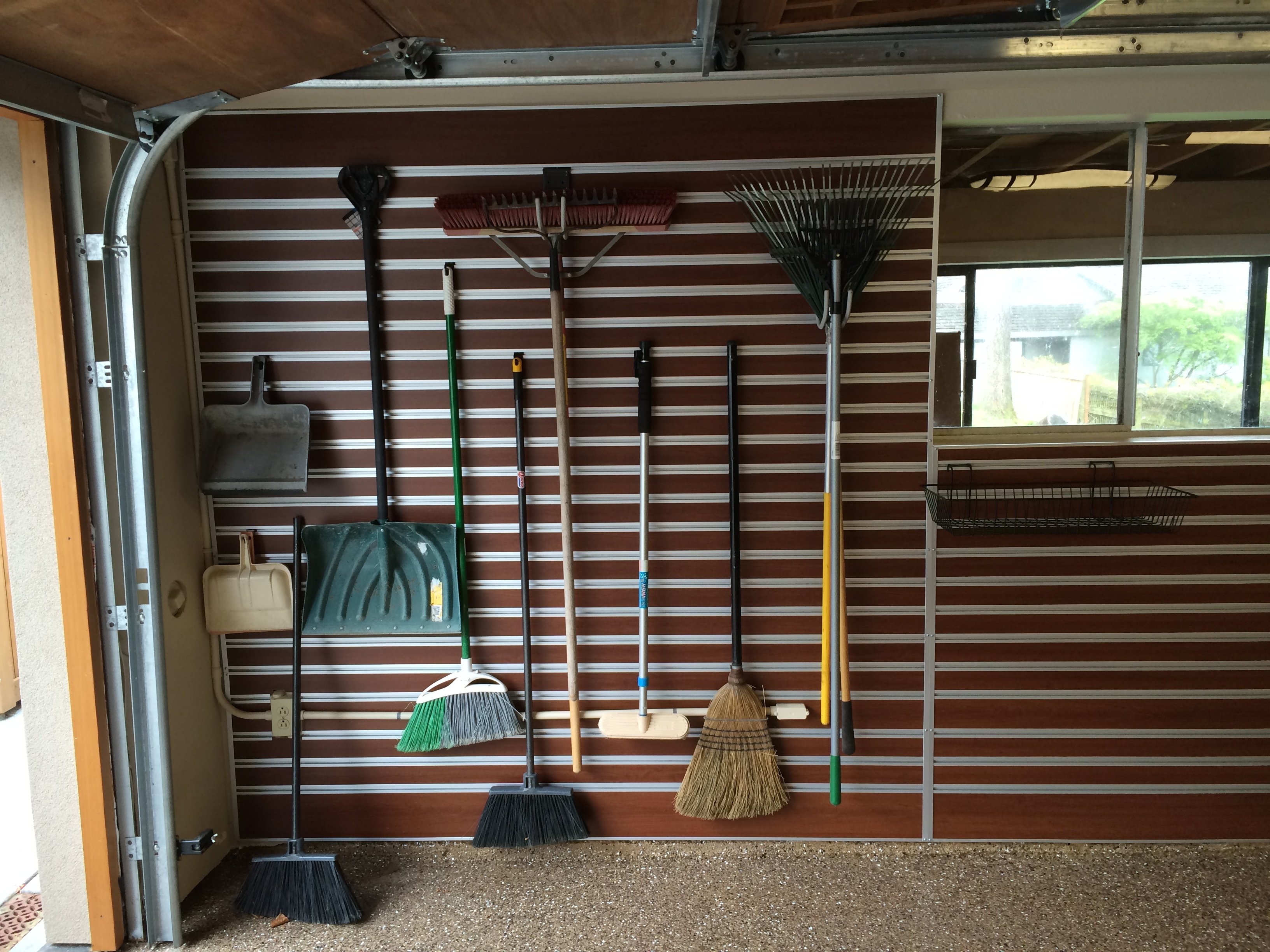 slat wall for garage organization of yard tools
